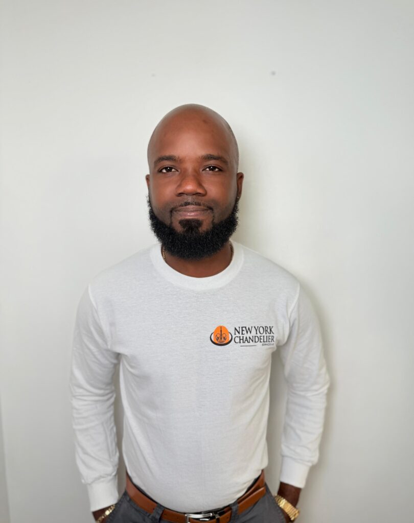 Man wearing New York Chandelier logoed white shirt