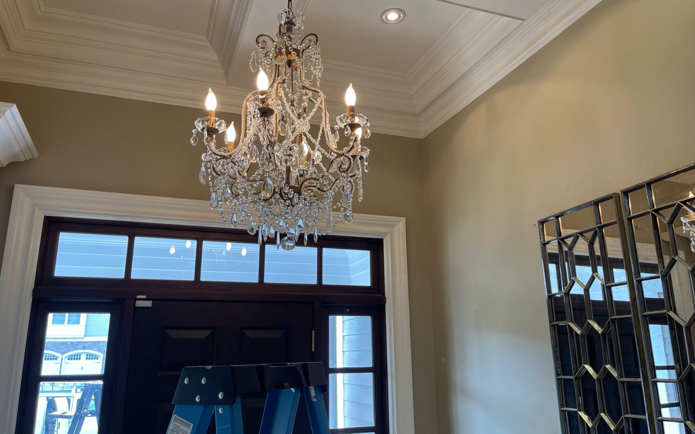 Crystal chandelier installation in a New York home. Professional chandelier services.