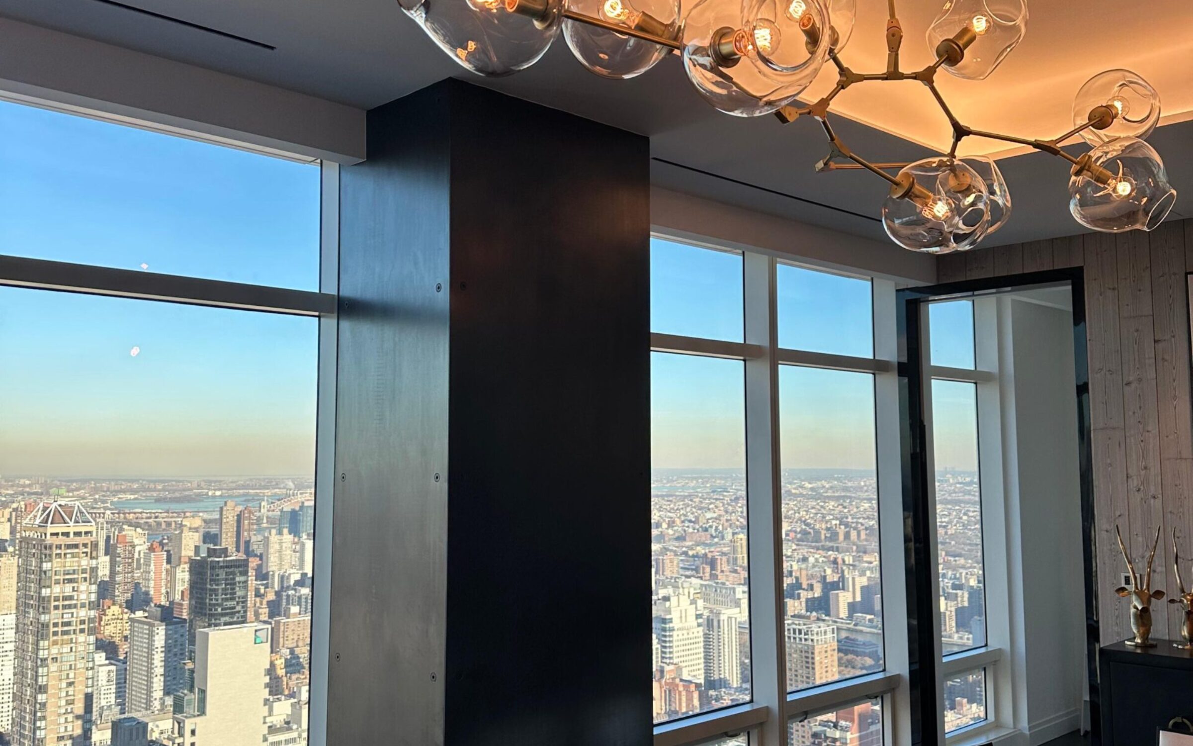 Modern dining room with city view and glass bubble chandelier