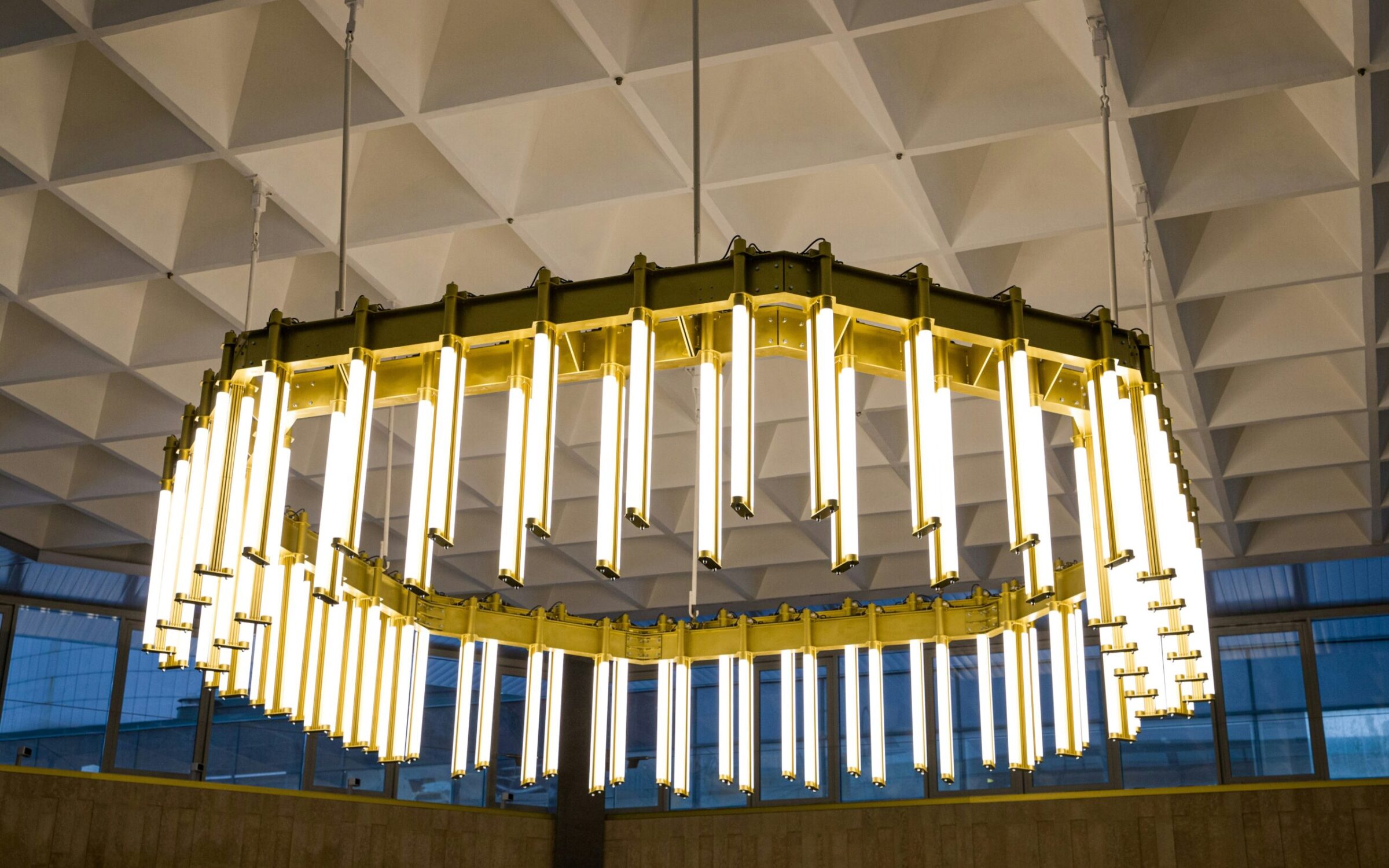 Modern gold chandelier with numerous LED lights. New York chandelier services.