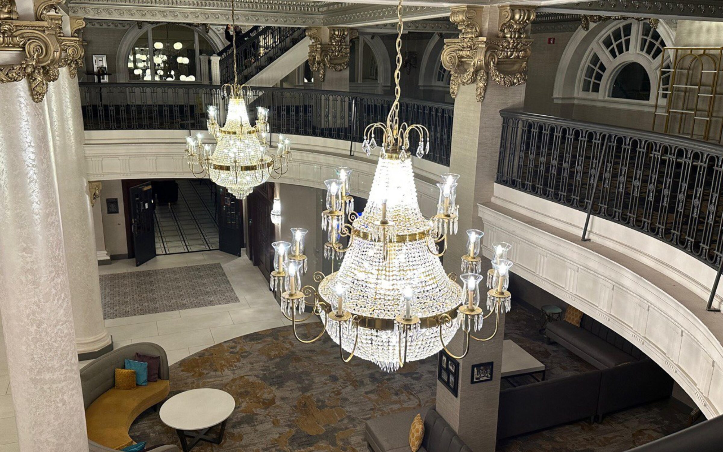 Elegant crystal chandeliers in a luxurious lobby with ornate architecture